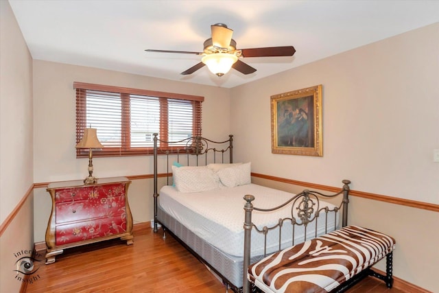 bedroom with ceiling fan and wood-type flooring