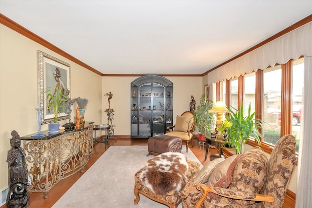 living room featuring hardwood / wood-style floors and crown molding