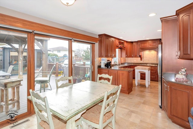 kitchen featuring sink and stainless steel refrigerator