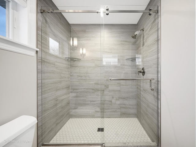 bathroom with toilet and walk in shower