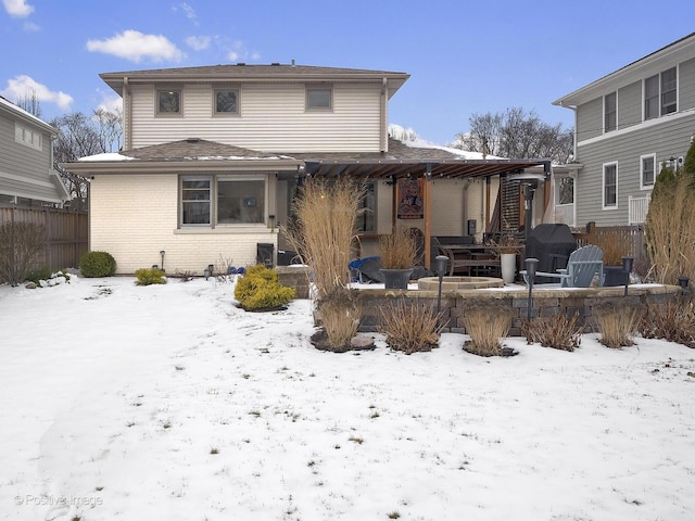 view of snow covered back of property