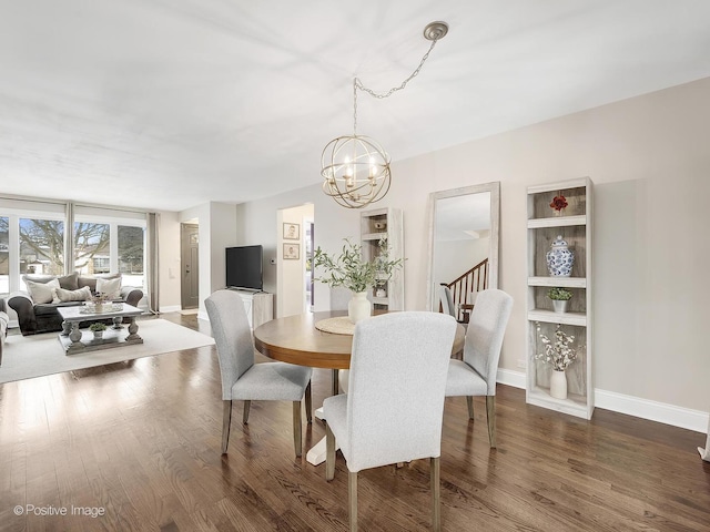 dining area featuring dark hardwood / wood-style floors and a notable chandelier