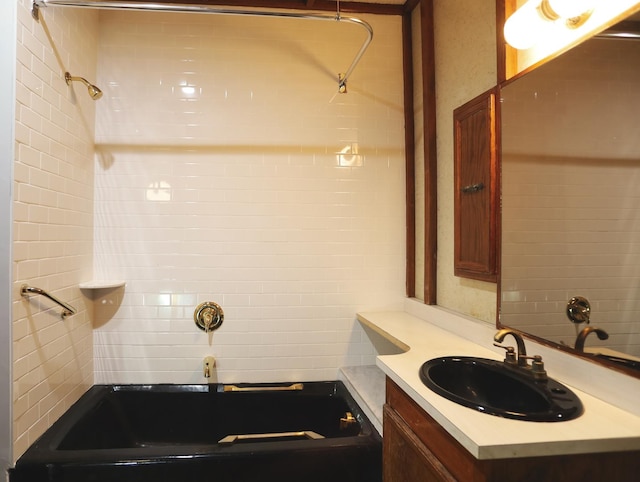 bathroom with shower / tub combination, tile walls, and vanity