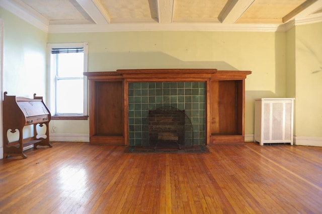 living room featuring coffered ceiling, beamed ceiling, hardwood / wood-style floors, and a tile fireplace