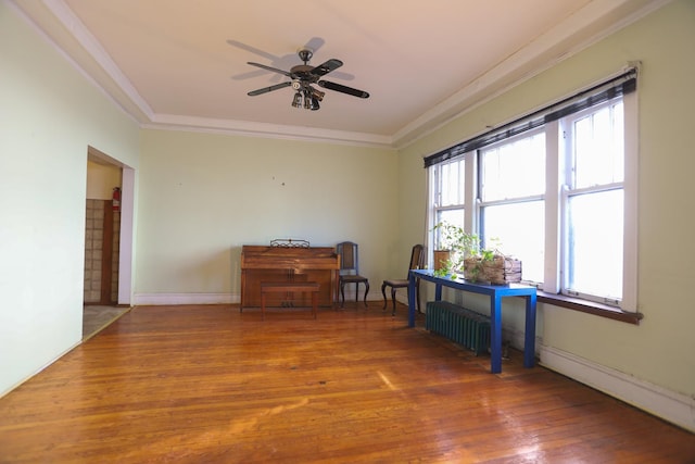 miscellaneous room with ceiling fan, radiator heating unit, hardwood / wood-style flooring, and a wealth of natural light