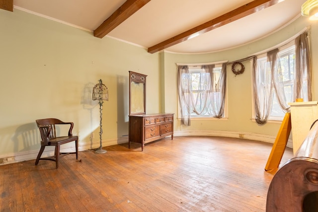 sitting room featuring beam ceiling and hardwood / wood-style floors