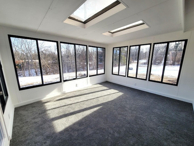 unfurnished sunroom with a wealth of natural light and a skylight