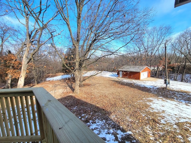 snowy yard featuring an outdoor structure