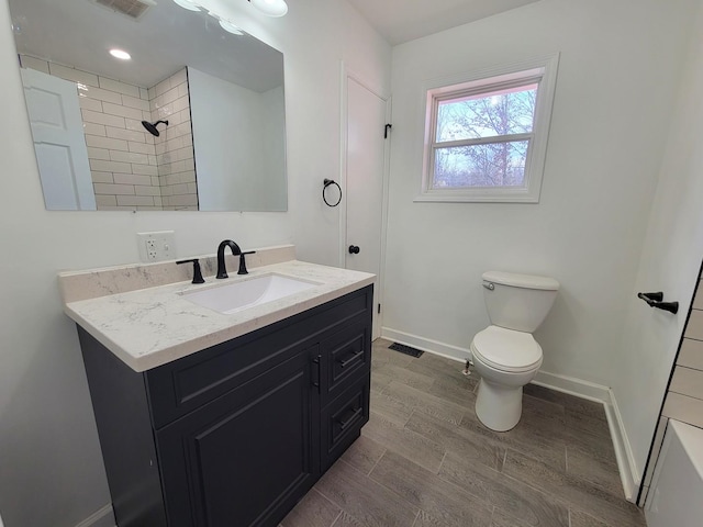 bathroom featuring toilet and vanity