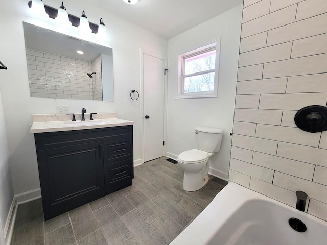 full bathroom with toilet, vanity, and tiled shower / bath combo