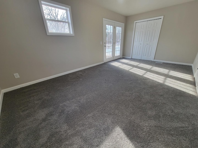 carpeted empty room featuring french doors