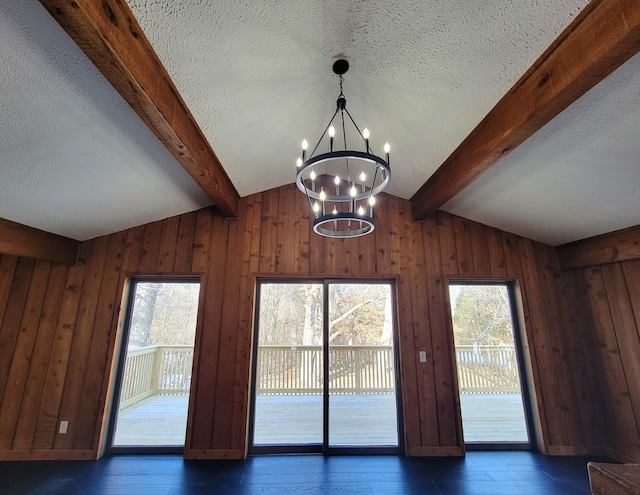 details with hardwood / wood-style flooring, a textured ceiling, beam ceiling, and an inviting chandelier