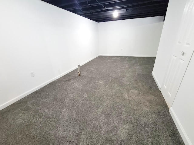 basement featuring dark colored carpet