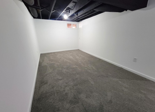 basement featuring dark colored carpet