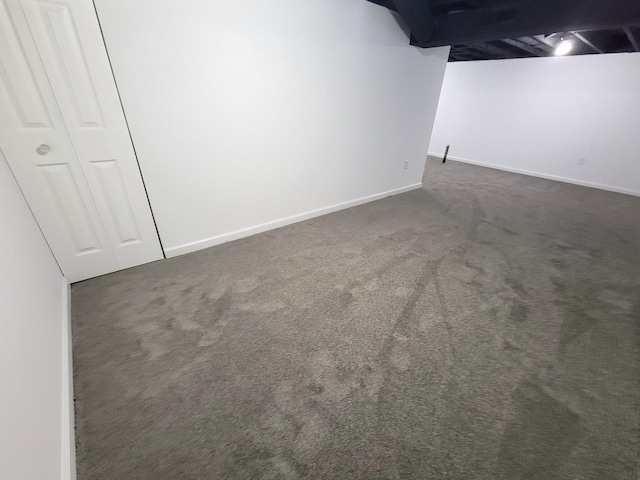 basement featuring dark carpet