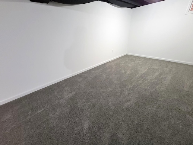 basement with dark colored carpet