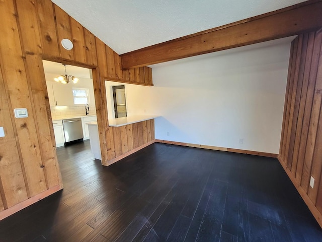 interior space featuring sink, vaulted ceiling with beams, dark hardwood / wood-style flooring, and an inviting chandelier