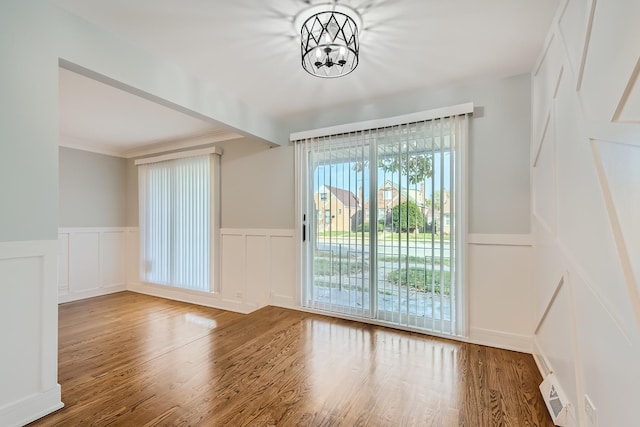 interior space featuring wood-type flooring and a chandelier