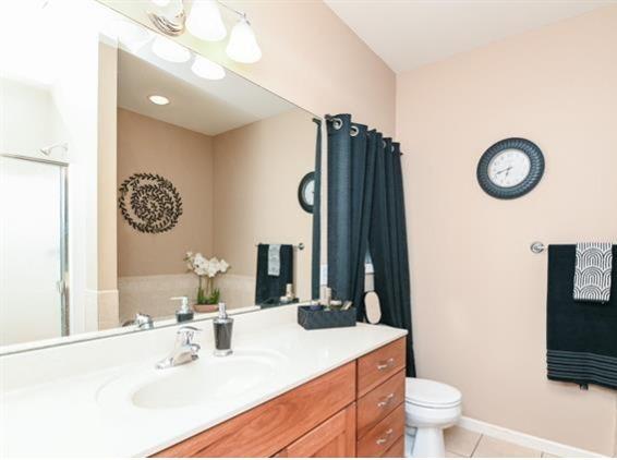 521 E 2700 N Rd, Deland, IL 61839 - bathroom with toilet, tile patterned floors, and vanity