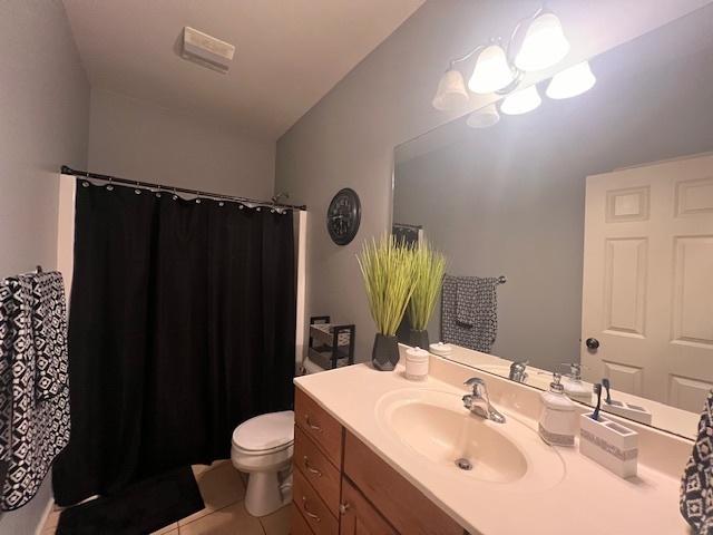 521 E 2700 N Rd, Deland, IL 61839 - bathroom with toilet, tile patterned flooring, and vanity