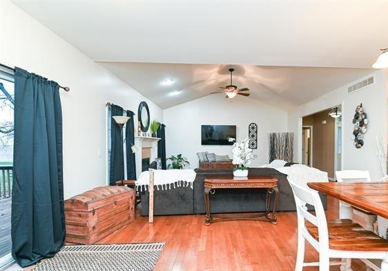 521 E 2700 N Rd, Deland, IL 61839 - living room with hardwood / wood-style flooring, vaulted ceiling, and ceiling fan