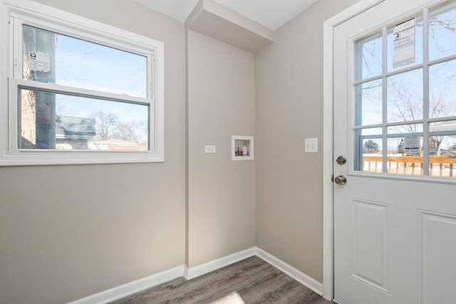 laundry area featuring washer hookup, a wealth of natural light, and dark hardwood / wood-style floors