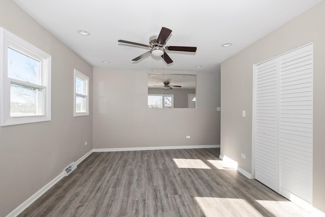 spare room with ceiling fan and dark hardwood / wood-style flooring