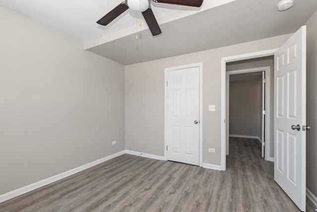 unfurnished bedroom featuring ceiling fan and hardwood / wood-style flooring