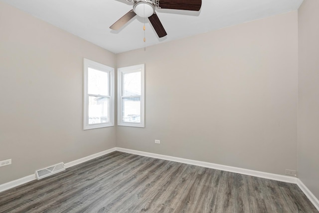 unfurnished room featuring ceiling fan and dark hardwood / wood-style flooring