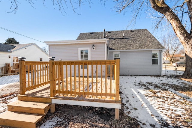 snow covered property with a deck