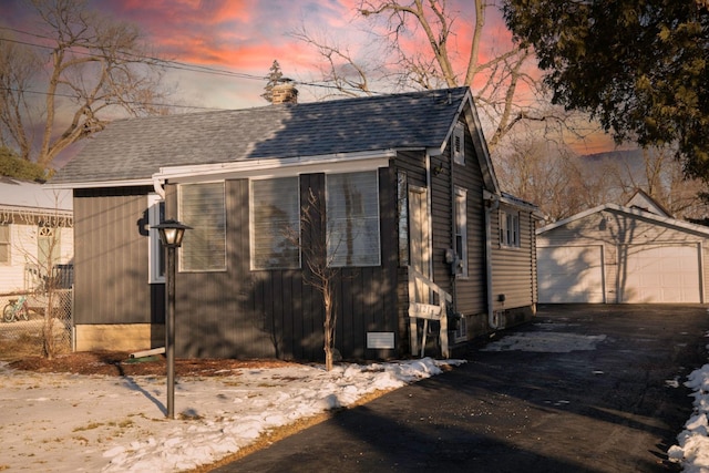 exterior space with a garage and an outdoor structure