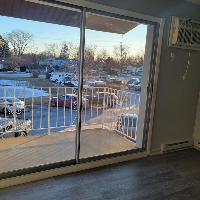 doorway featuring an AC wall unit, dark hardwood / wood-style floors, and a baseboard radiator