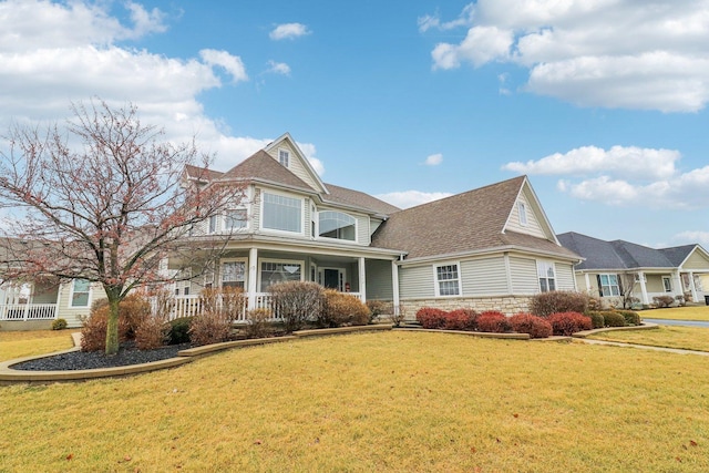 view of front of home with a porch and a front lawn