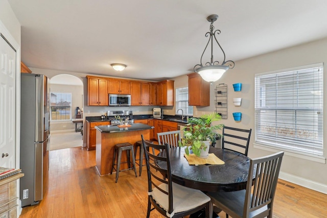 dining space featuring sink and light hardwood / wood-style flooring