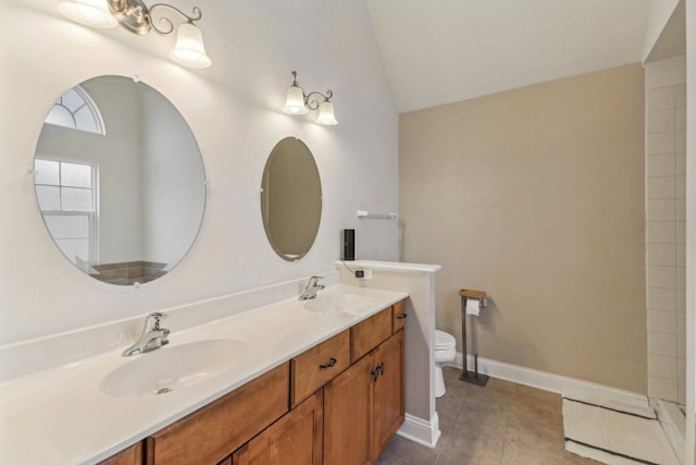 bathroom featuring lofted ceiling, toilet, tile patterned flooring, and vanity