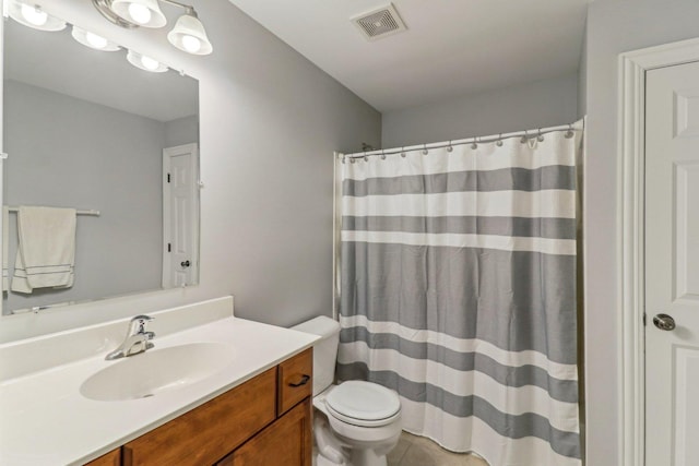 bathroom featuring vanity, tile patterned flooring, curtained shower, and toilet