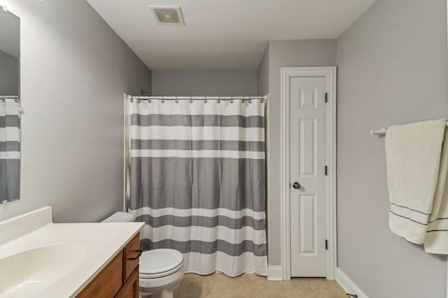 bathroom with vanity, a shower with curtain, tile patterned floors, and toilet