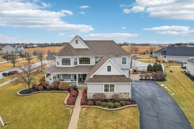 view of front of house with a porch and a front lawn