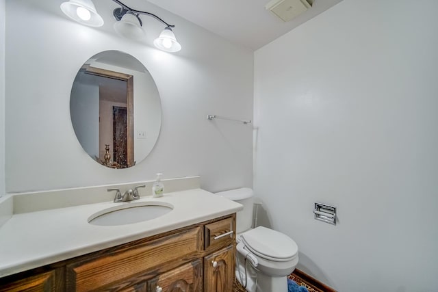 bathroom with toilet and vanity