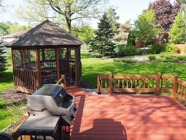 wooden terrace with a gazebo, grilling area, and a yard