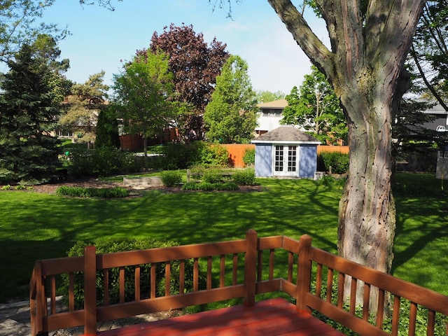 view of yard with a deck and an outbuilding