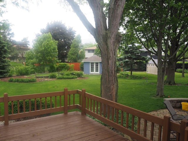 deck featuring an outbuilding and a yard