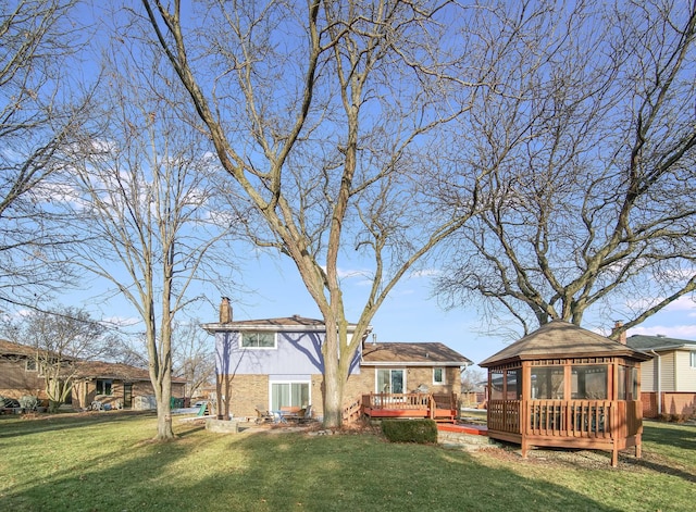 view of yard with a wooden deck and a gazebo