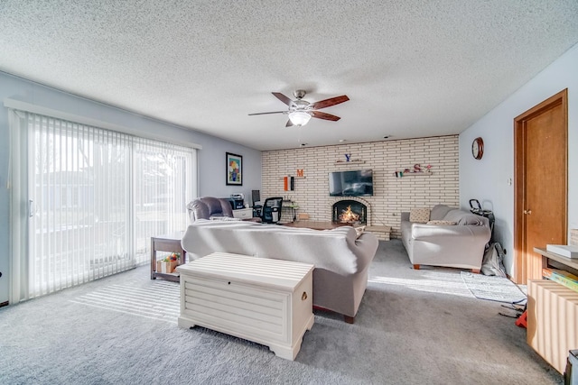 living room with light colored carpet, a fireplace, and a textured ceiling