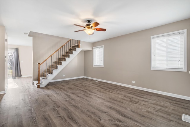 interior space featuring dark wood-type flooring and ceiling fan