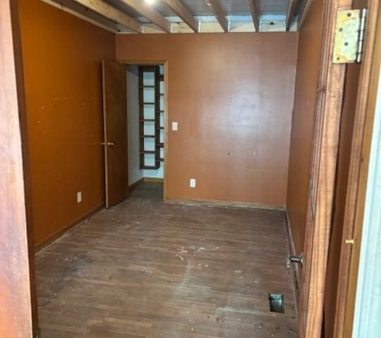 unfurnished room featuring dark wood-type flooring