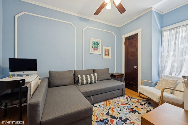 living area featuring a ceiling fan, crown molding, and wood finished floors