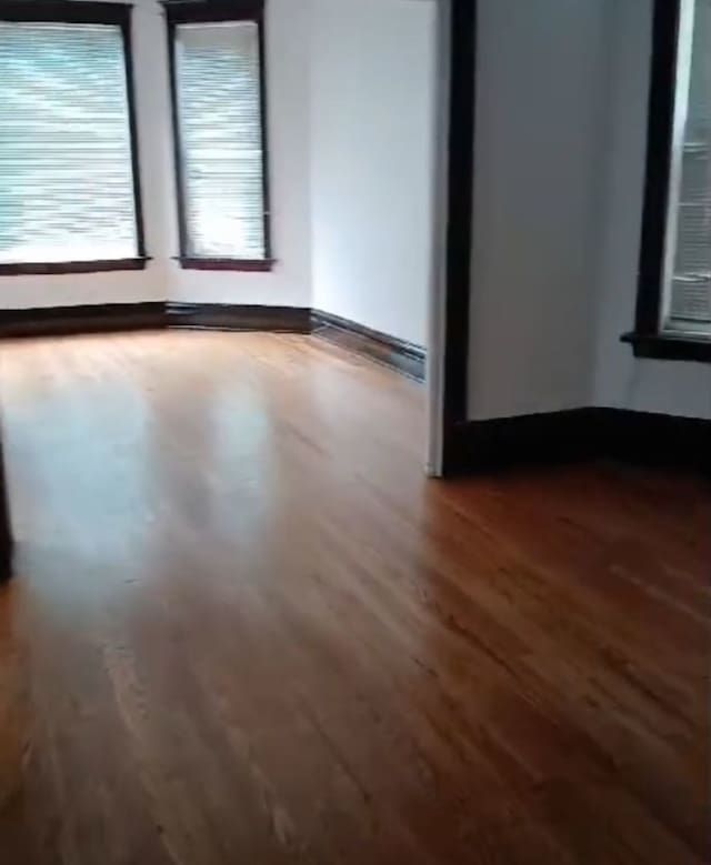 empty room with hardwood / wood-style flooring