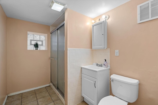 bathroom featuring vanity, tile patterned floors, a shower with door, and toilet