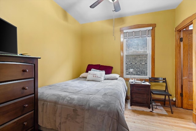 bedroom with light hardwood / wood-style flooring and ceiling fan